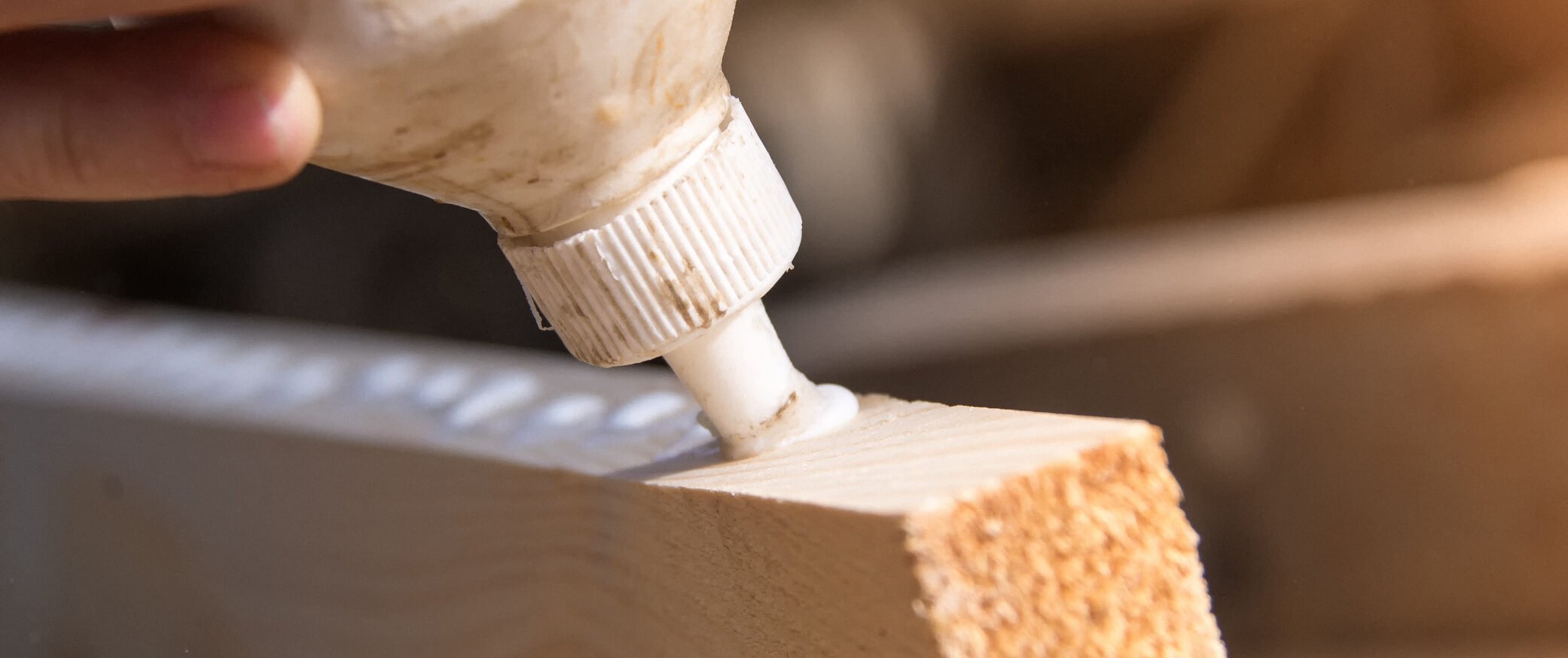White wood glue or adhesive on wood block